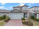 Beautiful two-story home showcasing a brick driveway and modern architectural details at 2289 Mystic Maze Ln, Minneola, FL 34715