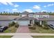Desirable two-story home with brick driveway in a suburban neighborhood at 2289 Mystic Maze Ln, Minneola, FL 34715