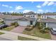 Home exterior features a brick driveway, well-maintained lawn, and a charming two-story facade at 2289 Mystic Maze Ln, Minneola, FL 34715