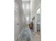 Bright hallway with natural light, leading to the entryway and powder room at 2289 Mystic Maze Ln, Minneola, FL 34715