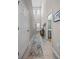 Inviting hallway with neutral tones, tiled floors, and a decorative rug leading to the front door at 2289 Mystic Maze Ln, Minneola, FL 34715