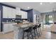 Modern kitchen with stainless steel appliances, granite countertops, and an island with bar seating at 2289 Mystic Maze Ln, Minneola, FL 34715