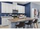 Contemporary kitchen with white cabinets, stainless steel appliances, and a spacious granite island at 2289 Mystic Maze Ln, Minneola, FL 34715