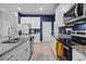 Modern kitchen boasts granite counters, stainless steel appliances, white cabinets, and tiled floors at 2289 Mystic Maze Ln, Minneola, FL 34715