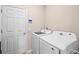 A well-equipped laundry room with a full-size washer and dryer at 2289 Mystic Maze Ln, Minneola, FL 34715
