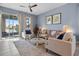 Bright living room with plush seating, sliding glass doors to screened lanai, and soft decor at 2289 Mystic Maze Ln, Minneola, FL 34715