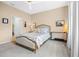 Cozy main bedroom features neutral-colored walls, carpet, ceiling fan, and stylish furniture at 2289 Mystic Maze Ln, Minneola, FL 34715