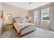 Inviting main bedroom with neutral walls, carpet, ceiling fan, stylish furniture, and natural lighting at 2289 Mystic Maze Ln, Minneola, FL 34715
