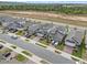 The aerial view shows a street lined with houses, each with its own driveway and well-kept landscaping at 2289 Mystic Maze Ln, Minneola, FL 34715