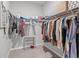 Organized walk-in closet with hanging clothes, shelves, and shoe racks at 2289 Mystic Maze Ln, Minneola, FL 34715
