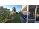 Landscaped backyard view, showing a screened-in patio and a well-maintained lawn for outdoor enjoyment at 2304 Jonesbury Run, The Villages, FL 32162