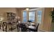 Cozy dining area featuring a dark wood table, black chairs, a wine rack, and plenty of natural light at 2304 Jonesbury Run, The Villages, FL 32162
