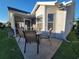 Features an outdoor patio area with seating, adjacent to a screened lanai, ideal for relaxing and entertaining at 2304 Jonesbury Run, The Villages, FL 32162