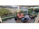 Inviting screened patio featuring outdoor seating and views of the manicured backyard at 2304 Jonesbury Run, The Villages, FL 32162