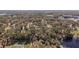 Aerial view of a large parcel of land with trees, lakes and a neighborhood of homes at 2541 Lake Griffin Rd, Lady Lake, FL 32159