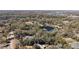 An expansive aerial view highlighting the lush landscape and tranquil pond at 2541 Lake Griffin Rd, Lady Lake, FL 32159