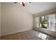 Cozy bedroom with carpet floors and a window providing natural light at 2541 Lake Griffin Rd, Lady Lake, FL 32159