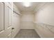 Walk in closet featuring neutral carpet, white walls, and adjustable metal shelving at 2541 Lake Griffin Rd, Lady Lake, FL 32159