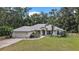 Charming single-story home featuring a well-manicured lawn, attached two-car garage, and a welcoming front porch at 2541 Lake Griffin Rd, Lady Lake, FL 32159