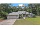 Charming single-story home featuring a well-manicured lawn, attached two-car garage, and a welcoming front porch at 2541 Lake Griffin Rd, Lady Lake, FL 32159