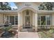 Close-up of the home's entryway featuring a decorative front door and stylish overhead lighting at 2541 Lake Griffin Rd, Lady Lake, FL 32159