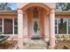 Arched entryway featuring a white front door flanked by columns and decorative overhead lighting at 2541 Lake Griffin Rd, Lady Lake, FL 32159