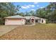 Charming single-story home featuring a well-maintained front yard and attached two car garage at 2541 Lake Griffin Rd, Lady Lake, FL 32159