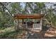 Wooden gazebo in a leafy setting with rustic charm and seating area at 2541 Lake Griffin Rd, Lady Lake, FL 32159