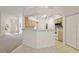 Bright kitchen boasts a breakfast bar, white appliances, and wooden cabinets offering ample storage at 2541 Lake Griffin Rd, Lady Lake, FL 32159