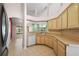Bright kitchen with wood cabinets, tile floors, and open layout to adjoining living spaces at 2541 Lake Griffin Rd, Lady Lake, FL 32159