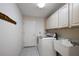 Functional laundry room with washer, dryer, utility sink and additional storage cabinets at 2541 Lake Griffin Rd, Lady Lake, FL 32159