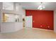 Spacious living room with tile floors and open access to the kitchen, bright accent wall at 2541 Lake Griffin Rd, Lady Lake, FL 32159