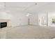 Bright and spacious living room area with carpet flooring, a fireplace, and a view of the front entryway at 2541 Lake Griffin Rd, Lady Lake, FL 32159