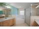 Main bathroom with a large tub, glass-enclosed shower, and vanity at 2541 Lake Griffin Rd, Lady Lake, FL 32159