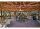 Outdoor kitchen on a wooden deck with a picnic table, a ceiling fan, and wooded views at 2541 Lake Griffin Rd, Lady Lake, FL 32159