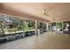 Large screened lanai with tile flooring, multiple ceiling fans, and scenic backyard views at 2541 Lake Griffin Rd, Lady Lake, FL 32159