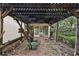 Rustic wooden pergola with a view of the screened in porch and backyard at 2541 Lake Griffin Rd, Lady Lake, FL 32159