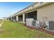 Spacious backyard with an air conditioning unit and screened patio at 255 Blueberry Ln, Davenport, FL 33837