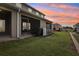 Exterior shot of the backyard with a screened patio and a view of neighboring homes at 255 Blueberry Ln, Davenport, FL 33837