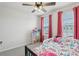 Bedroom features a ceiling fan, pink curtains, and carpet floors at 255 Blueberry Ln, Davenport, FL 33837