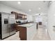 The kitchen features stainless steel appliances, granite countertops, and an island with a sink at 255 Blueberry Ln, Davenport, FL 33837