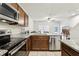 Open-concept kitchen boasts granite countertops and stainless steel appliances at 255 Blueberry Ln, Davenport, FL 33837