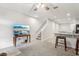 Bright living room featuring a ceiling fan, staircase, bar and access to the kitchen at 255 Blueberry Ln, Davenport, FL 33837