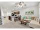 Inviting living room with modern ceiling fan, comfortable seating, and adjacent kitchen at 255 Blueberry Ln, Davenport, FL 33837