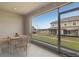 Enclosed patio provides scenic views of a community lawn and other homes at 255 Blueberry Ln, Davenport, FL 33837