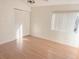Bedroom with hardwood floors, closet and a bright window with neutral paint at 2562 Lakeway Branch Way # 3002, Orlando, FL 32839