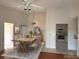Bright dining room featuring a wooden table, tile flooring, and an open view of the kitchen with white appliances at 2562 Lakeway Branch Way # 3002, Orlando, FL 32839