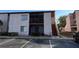Exterior view of a condo building with parking and mature landscaping at 2562 Lakeway Branch Way # 3002, Orlando, FL 32839