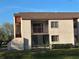 Exterior view of the building showing a porch, balcony, and manicured lawn at 2562 Lakeway Branch Way # 3002, Orlando, FL 32839
