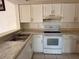 Kitchen with white cabinets, laminate countertops and white appliances at 2562 Lakeway Branch Way # 3002, Orlando, FL 32839
